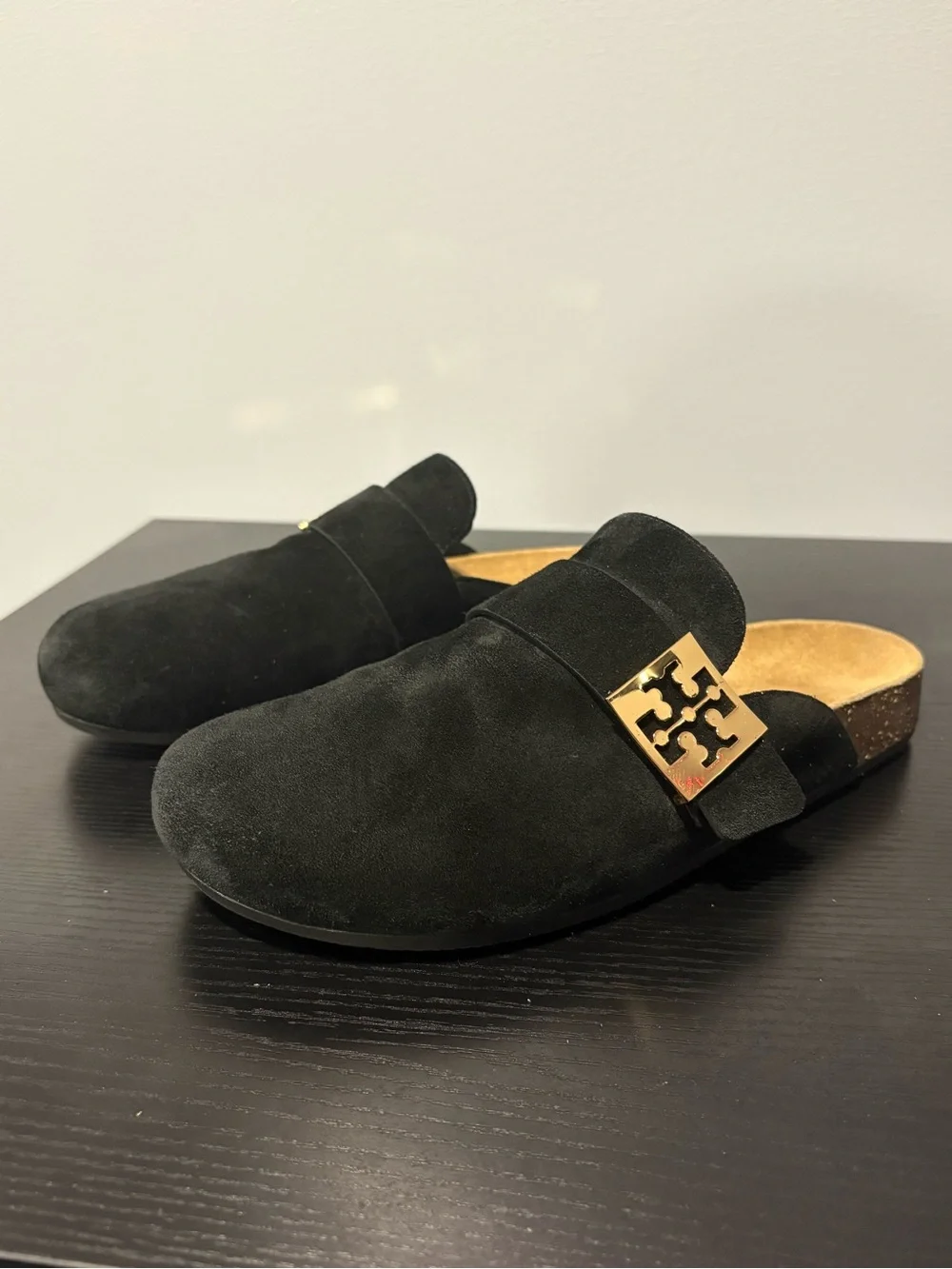 Tory Burch black suede slip-on mules in a size 7.5